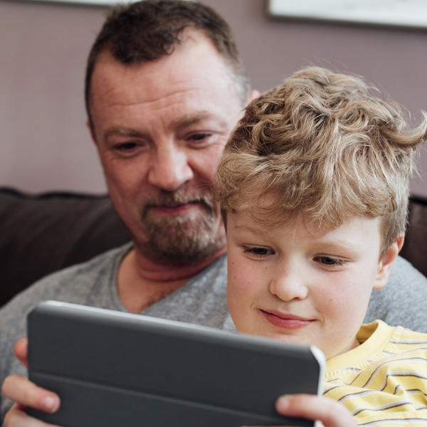 White father and son using ipad