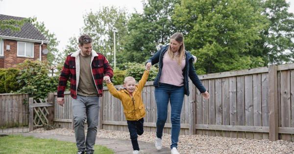 Young white family swinging child between them